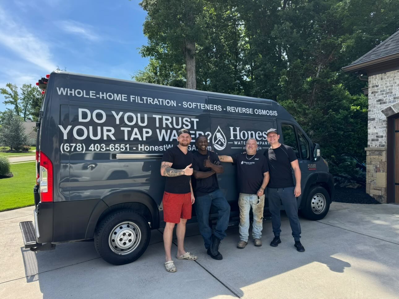 The Honest Water of Georgia team in front of the work van