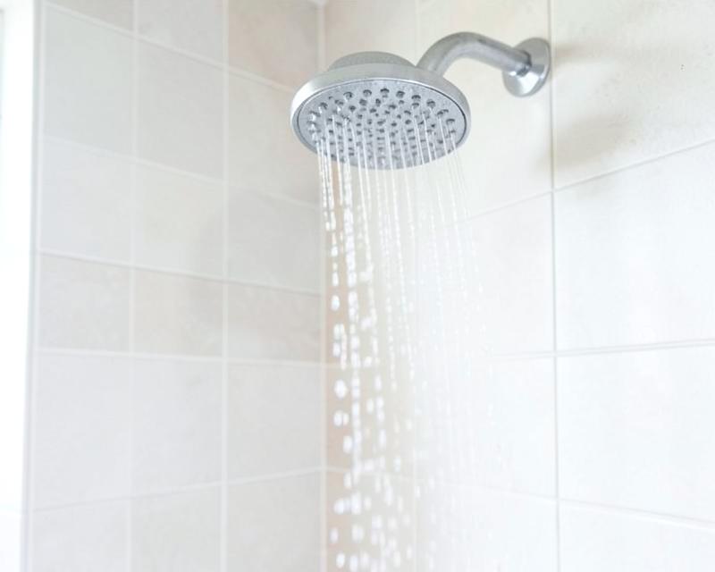 Clean chrome shower head with running water